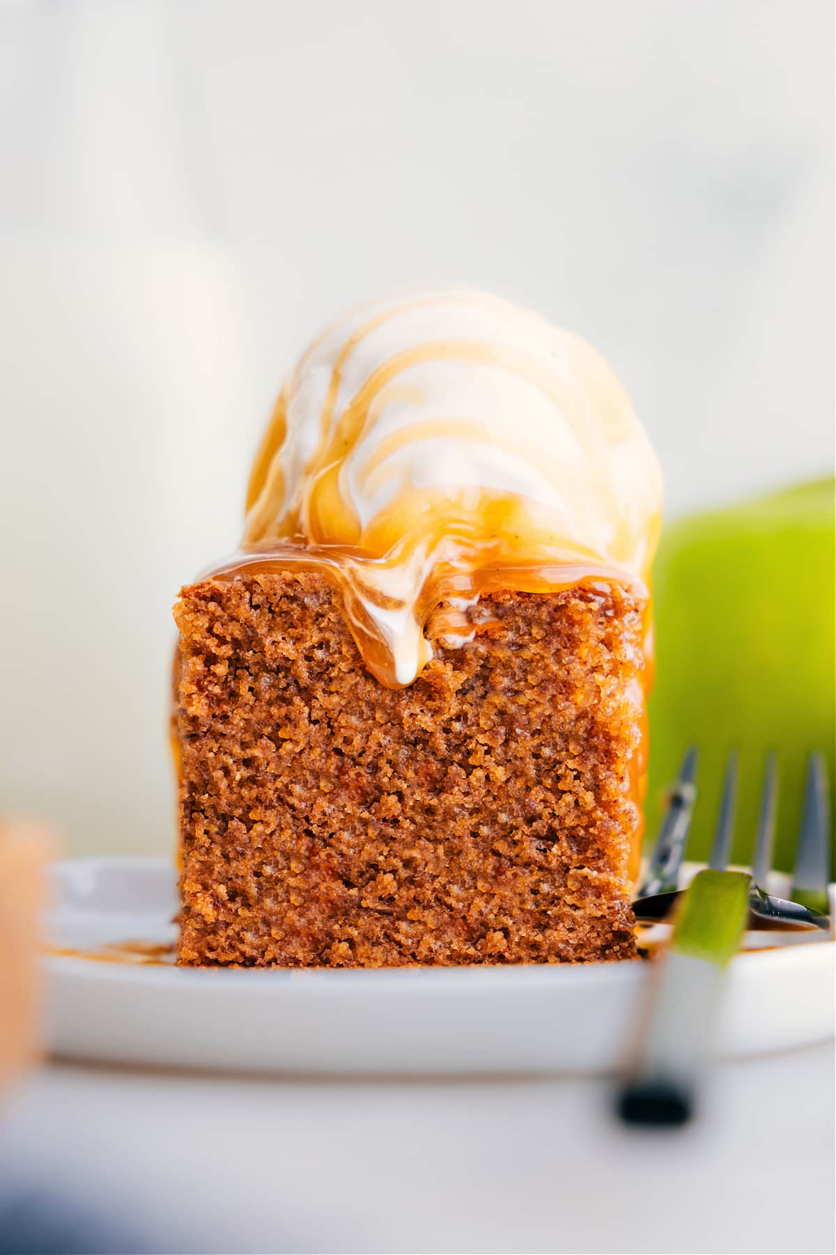Healthy Apple Cake Recipe Serve Healthy Apple Cake on a plate topped with ice cream.