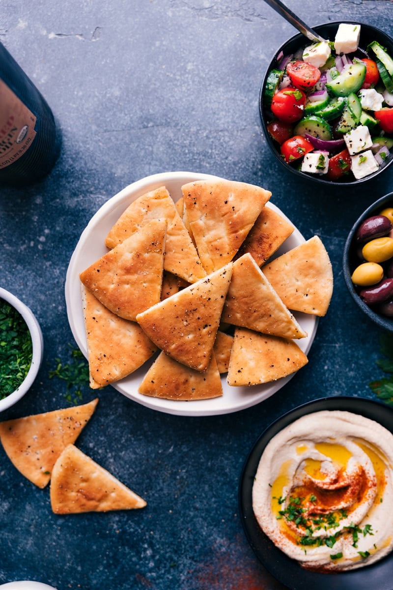 Homemade Pita Chips are out-of-this-world delicious! These big, thick, and crunchy chips are the perfect vehicle for a good dip and the ultimate addition to a fun Mediterranean spread. Recipe via chelseasmessyapron #appetizer #best #quick #easy #simple #snacks #pita #chips Overhead image of Pita Chips
