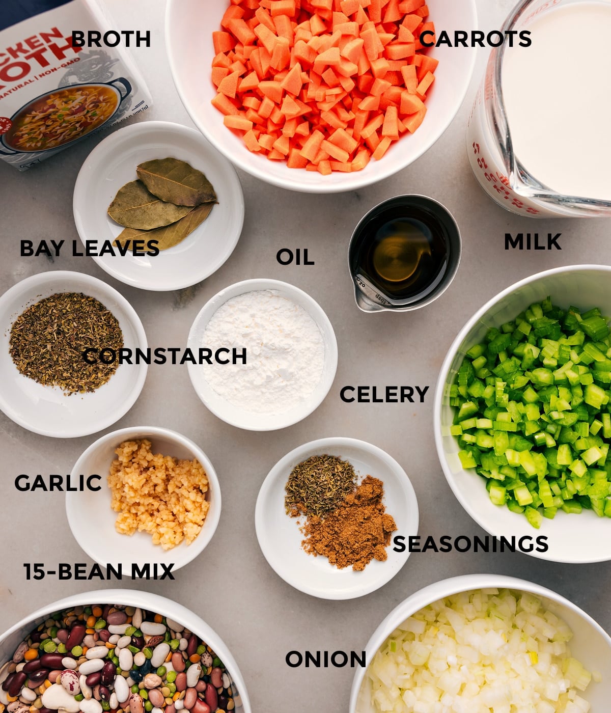Ingredients In 15-Bean Soup Recipe All the ingredients are prepped for easy assemblyโveggies, milk, bay leaves, beans, garlic, cornstarch, seasonings, and broth.