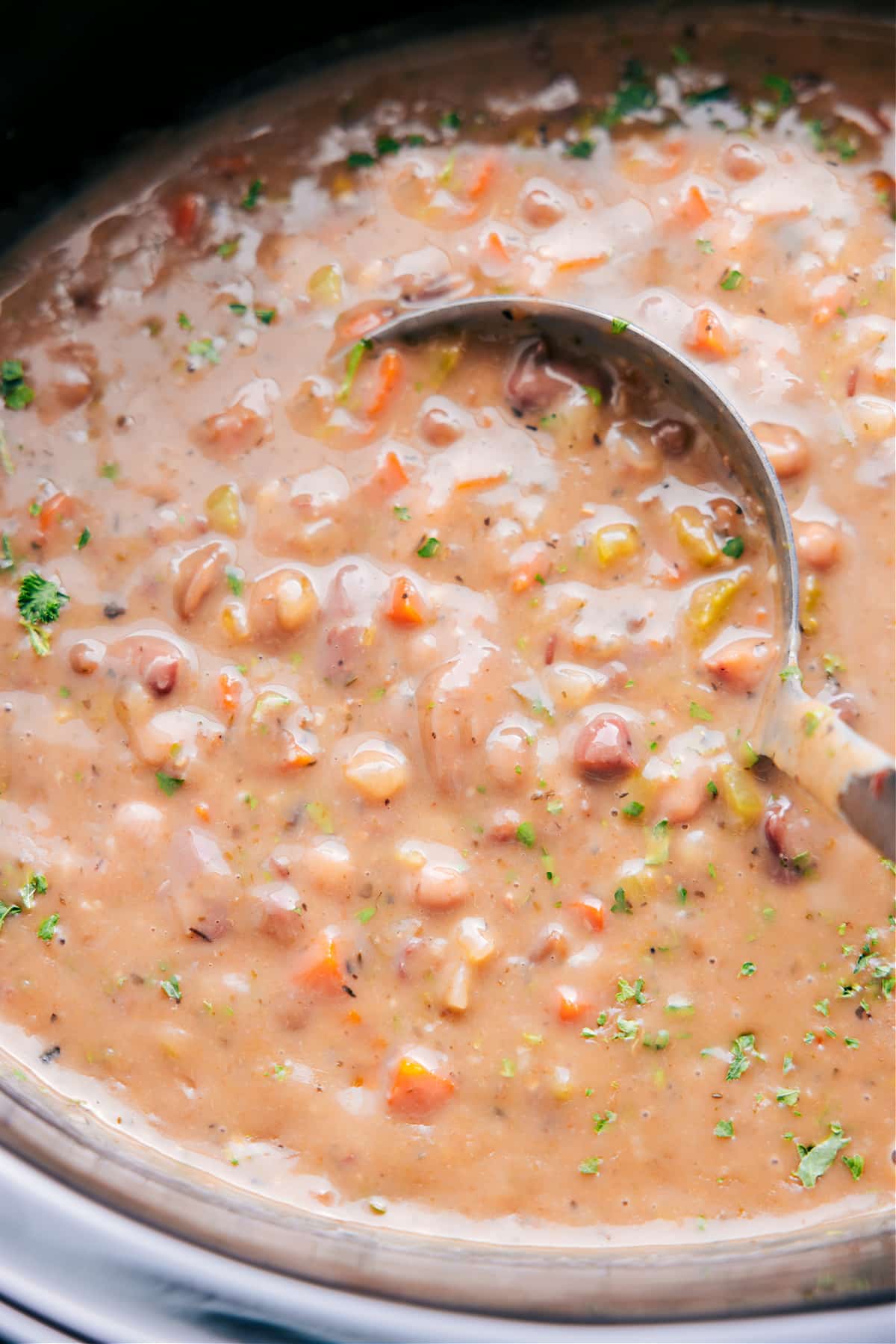 Delicious And Flavorful 15-Bean Soup Scooping up 15-Bean Soup with a ladle, ready to enjoy.