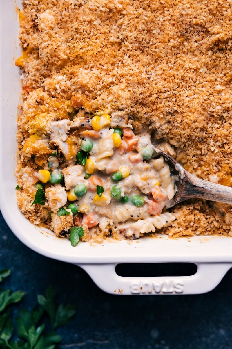 Chicken Noodle Casserole channels all the flavors you know and love from chicken noodle soup into a creamy, cheesy casserole dish the whole family will love! This is the absolute best-ever version of the popular casserole--it's got loads of veggies, tender chicken, a cheesy cream sauce, and a crunchy topping. Recipe via chelseasmessyapron #dinner #quick #easy #simple #best #familyfriendly #kidfriendly #comfortfood #chickennoodle #casserole Overhead image of the Chicken Noodle Casserole