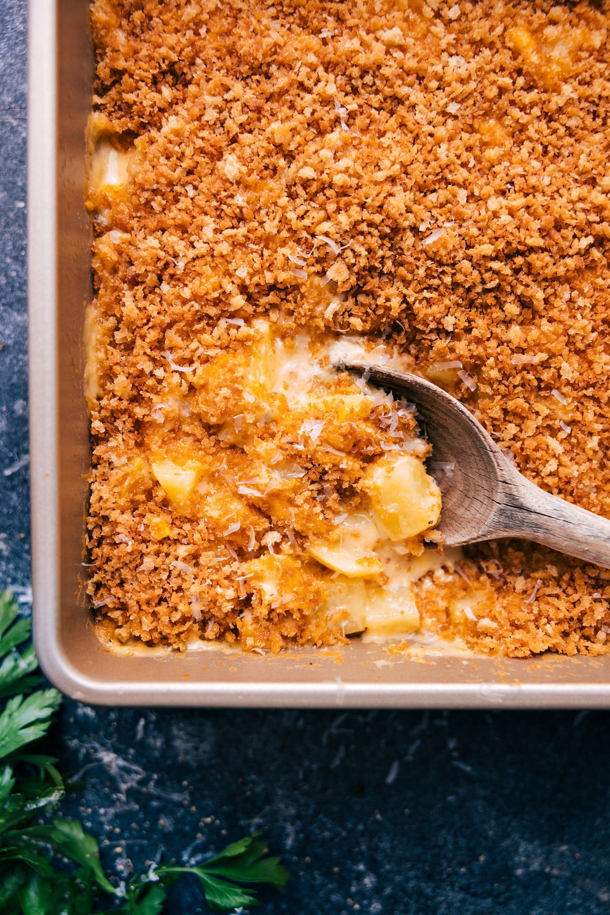 The Best Cheesy Potatoes Recipe Freshly baked Cheesy Potatoes with a big scoop ready to serve!