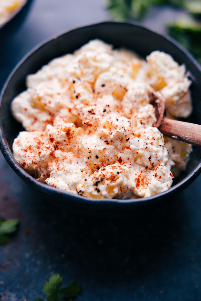 Old-fashioned Creamed Potatoes Recipe Everyone Needs Creamed Potatoes Recipe in a bowl with seasonings on top.