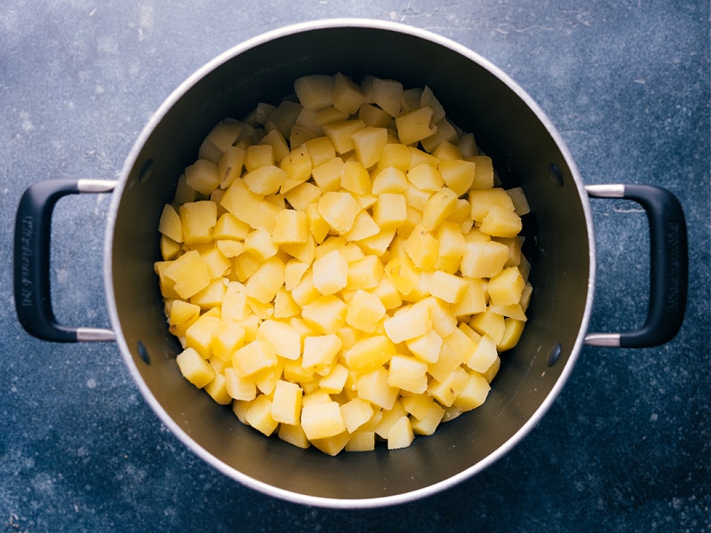 Old-fashioned Creamed Potatoes are one of the best potato side dishes around! These creamy potatoes require minimal ingredients and whip together quickly -- plus they're a great changeup from your typical mashed potatoes. Recipe via ChelseasMessyApron.com #creamedpotatoes #potatoes #creamy #familyfavorite #comfortfood #sidedish #sourcream #vegetarian The cooked potatoes strained and. in the pot for this creamed potatoes recipe.