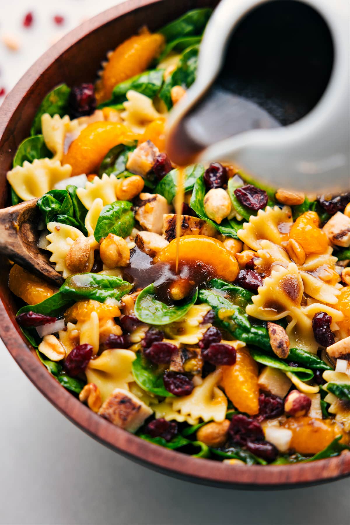 How To Make The Best Teriyaki Chicken Salad Recipe Teriyaki Chicken Salad dressing being poured over the dish ready to be tossed together and served.