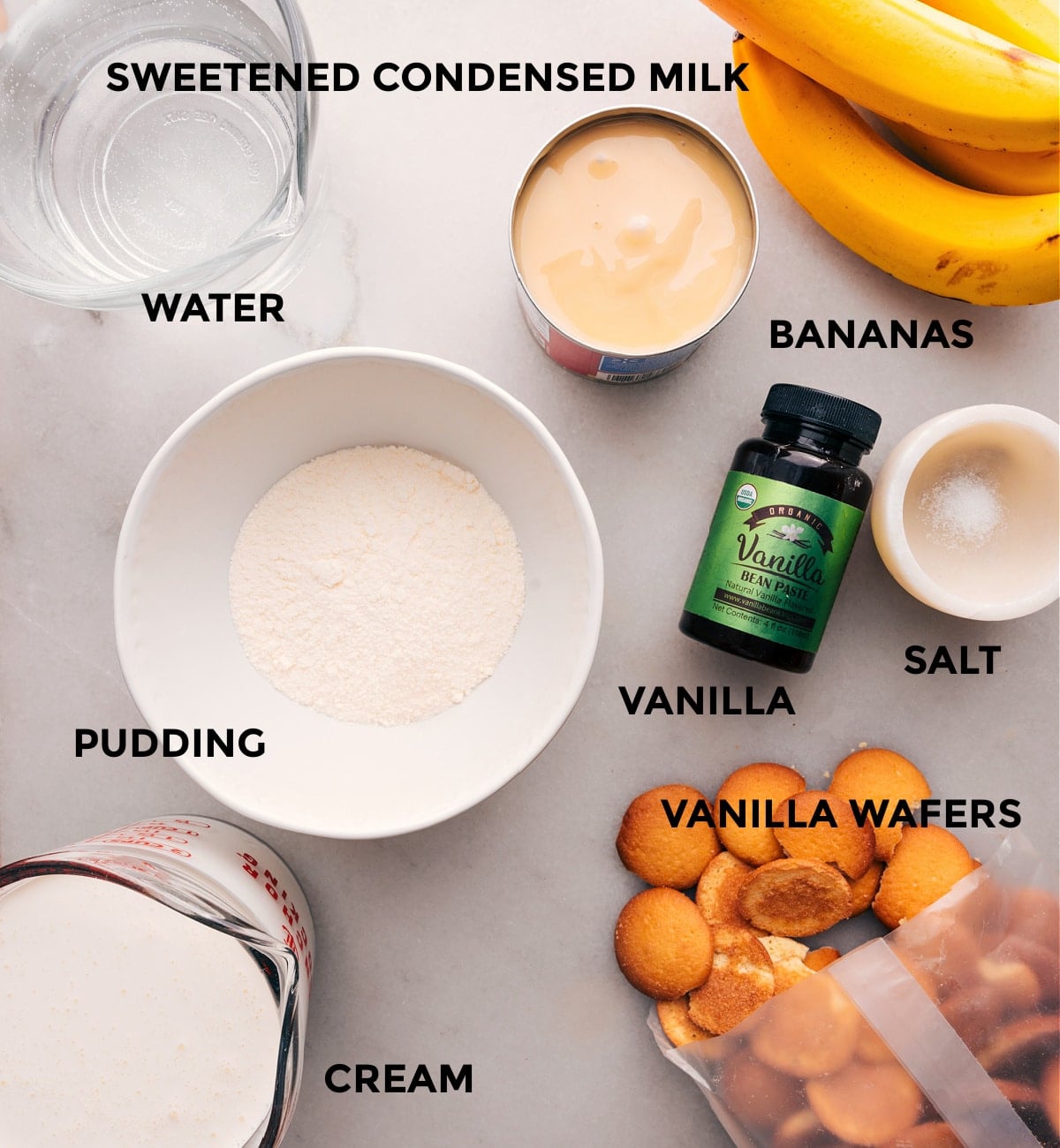 Ingredients for Banana Pudding Recipe An array of ingredients used to create this dessert, including sweetened condensed milk, vanilla wafers, cream, vanilla, and more, ready to be combined into a delectable dessert.