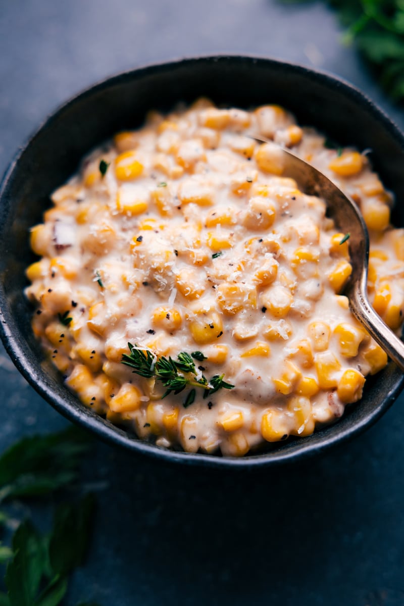 This is our favorite Creamed Corn recipe complete with loads of sweet corn, smoky bacon, and the best savory Parmesan cream sauce. Recipe via chelseasmessyapron #sidedish #thanksgiving #best #familyfriendly #comfortfood #creamy #creamed #corn Overhead image of Creamed Corn