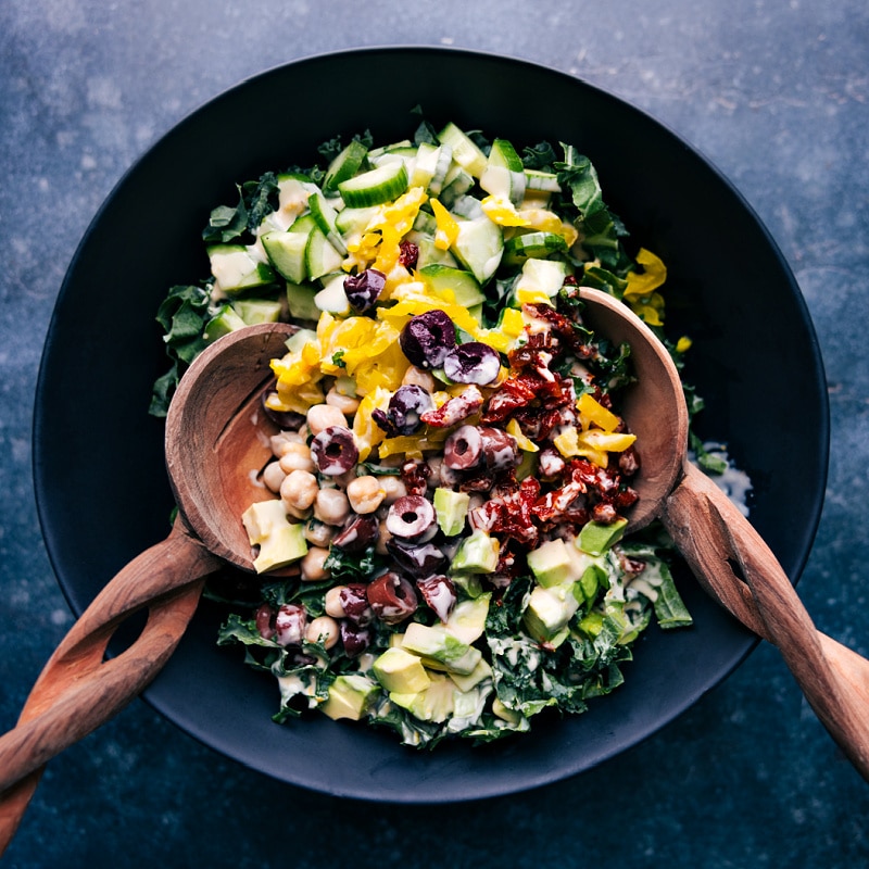 Tahini Dressing is luxuriously thick and creamy without any mayo or cream! It's delightfully flavored with a hint of lemon and touch of honey. Drizzle this dressing on your favorite salad. Recipe via chelseasmessyapron #salad #saladdressing #tahini #dressing Process shots of salad dressing-- image of the salad being tossed together with the dressing