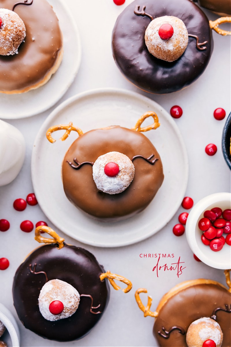 Christmas Donuts made to look like reindeer (specifically Rudolph)! These cute and festive donuts are simple to make and sure to be a hit this holiday season! Recipe via chelseasmessyapron #dessert #best #holiday #deer #holidaytreats #christmastreats #christmas #donuts Overhead image of the Christmas Donuts