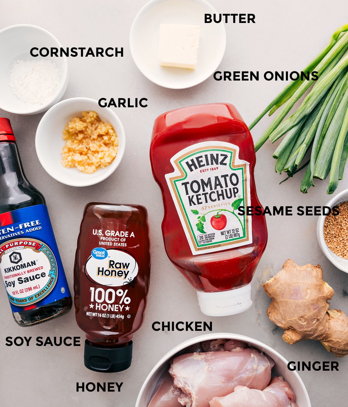 Ingredients In Honey Garlic Chicken Thighs All the ingredients for this recipe, including the meat, butter, green onions, garlic, cornstarch, ketchup, honey, soy sauce, sesame seeds, and ginger, are prepped for easy assembly.