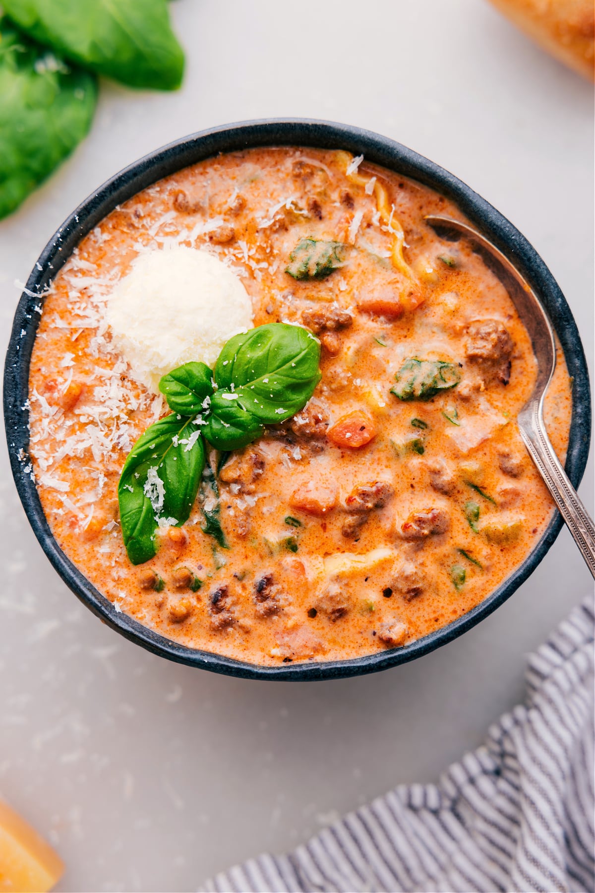 The Best Lasagna Soup Recipe Lasagna soup served in a bowl, topped with fresh basil and freshly grated Parmesan cheese.