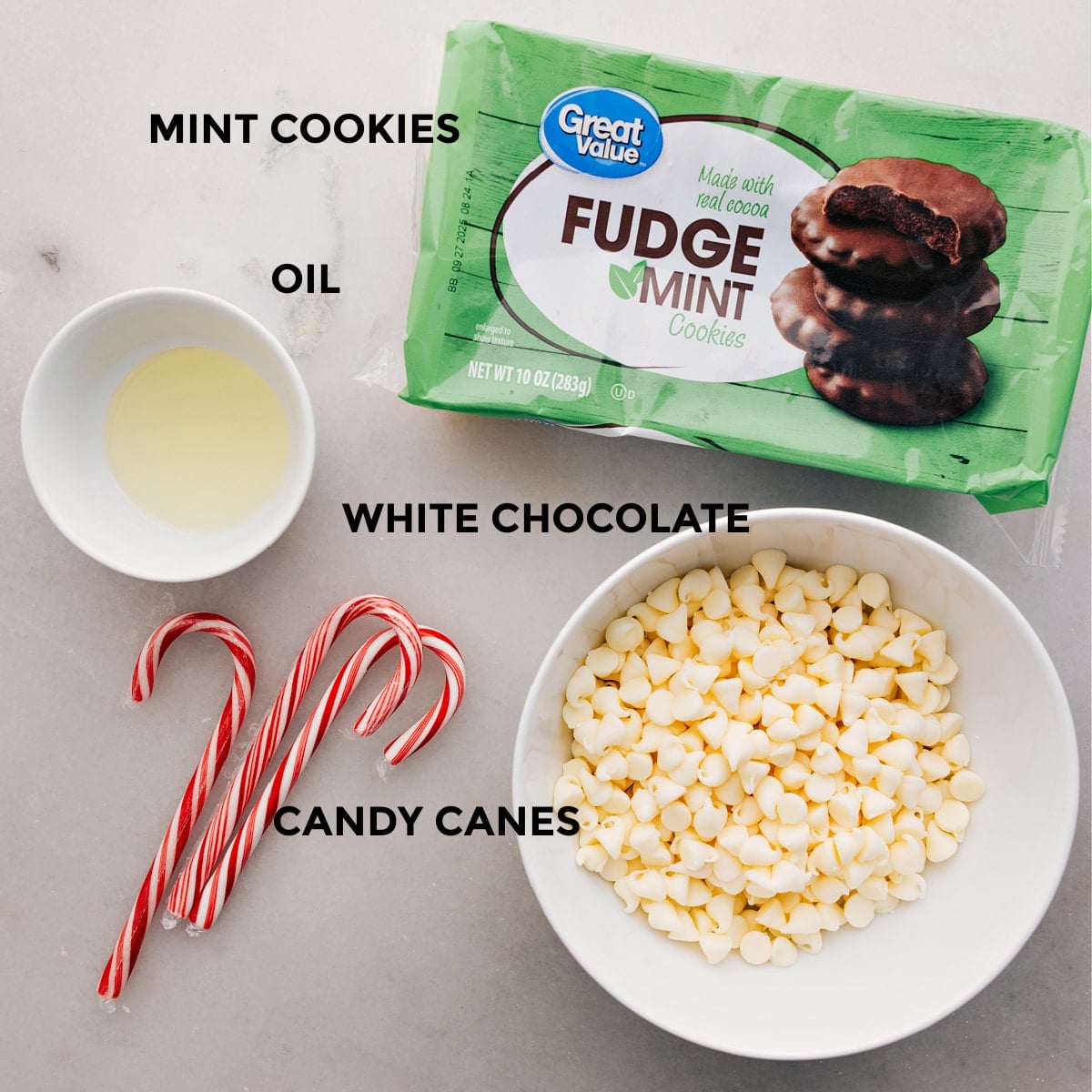Ingredients In Peppermint Cookies Recipe The four ingredients for this recipe are prepped and ready: fudge mint cookies, white chocolate, candy canes, and oil.
