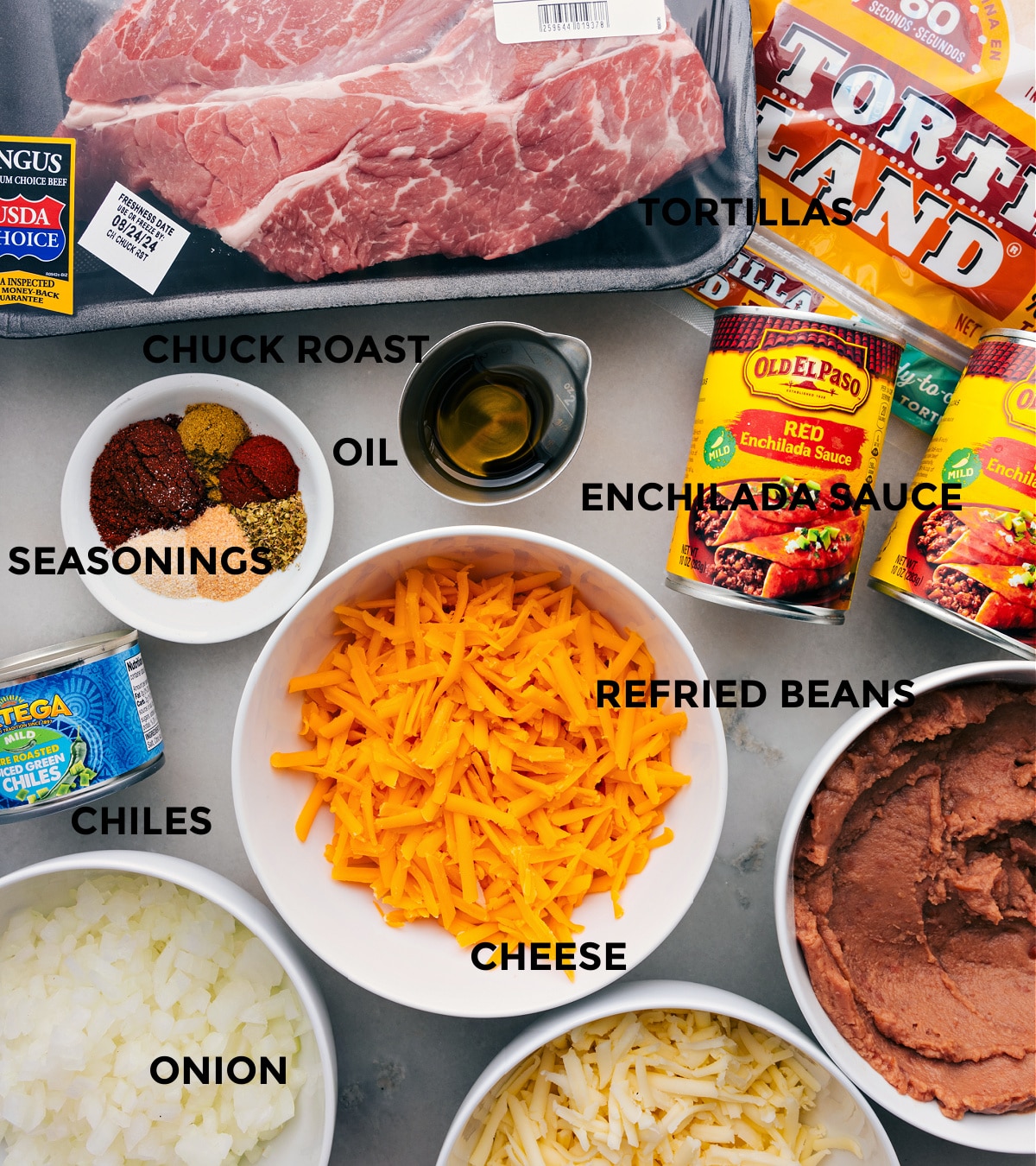 Shredded Beef Enchilada Ingredients Ready To Go All the ingredients for this recipe are prepped for easy assembly, including the meat, tortillas, sauce, beans, cheese, seasonings, and chiles.