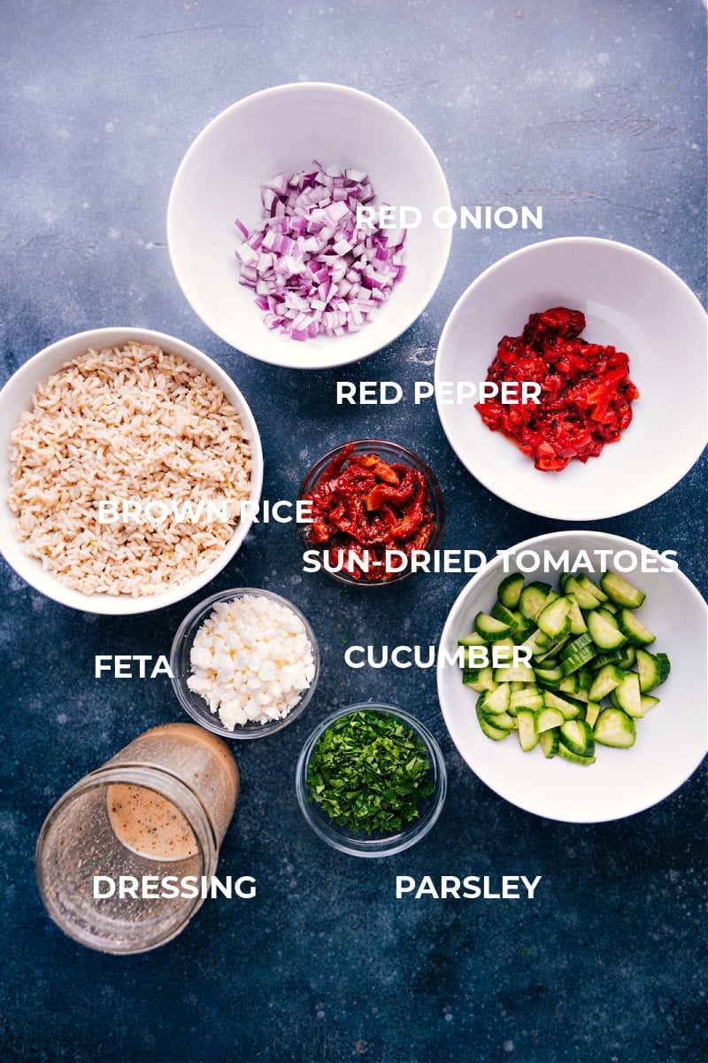 Looking for a tasty and healthy Mediterranean-inspired dish? Try this Brown Rice Salad! It's filled with crisp cucumbers, roasted red peppers, sun-dried tomatoes, red onion, parsley, and crumbled feta cheese, all tossed in a flavorful lemon dressing. Recipe via chelseasmessyapron #sidedish #best #quick #easy #simple #familyfriendly #kidfriendly #cucumber #sundriedtomatoes #brownrice #salad Ingredient shot-- image of all the ingredients used in this dish