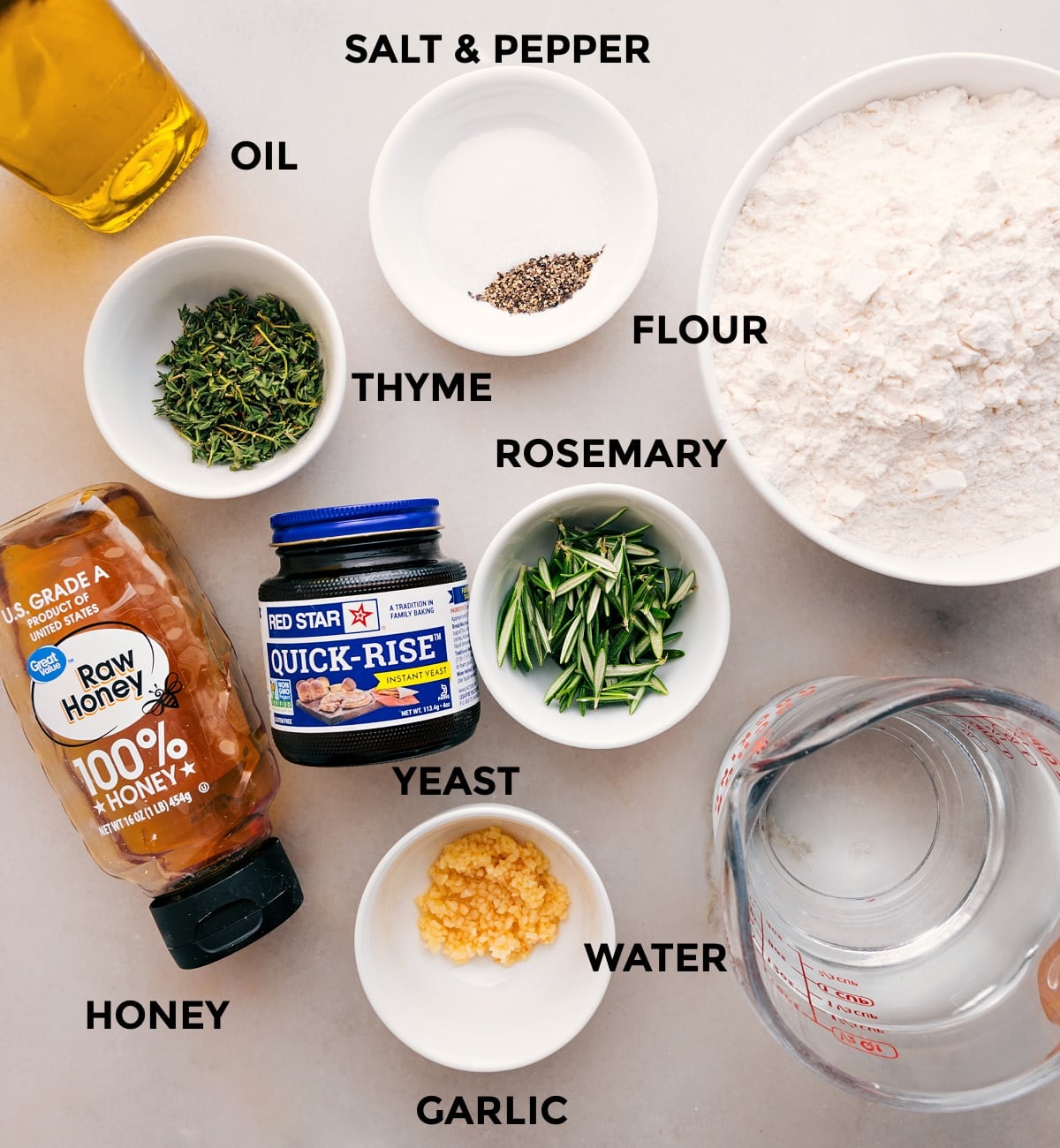 Ingredients In No-Knead Herb Bread This recipe's ingredientsโflour, oil, thyme, rosemary, yeast, water, and honeyโare prepped and ready for easy assembly.