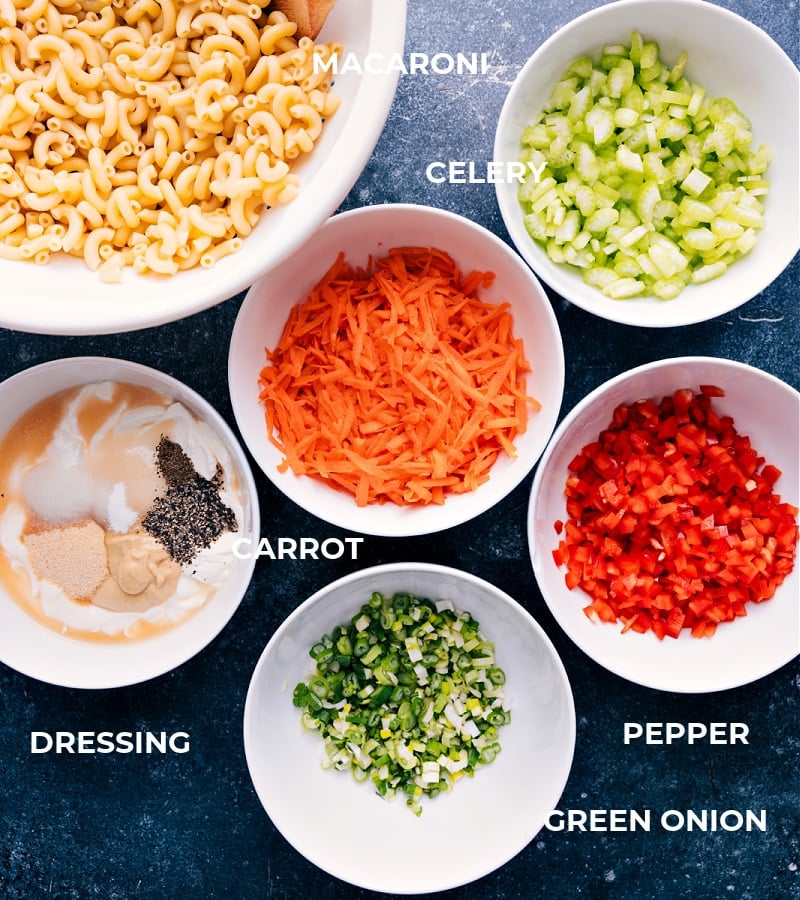 Looking for a delicious and satisfying Macaroni Salad that packs a punch of flavor? Look no further! Our special recipe is the perfect combination of tender pasta, crisp veggies, and a robustly flavored dressing that will leave your taste buds tingling. Recipe via ChelseasMessyApron.com #macaronisalad #pasta #sweet #tangy #veggies #vegetarian #picnic #summertime #salad #macaroni Ingredient shot: image of the components of Macaroni Salad