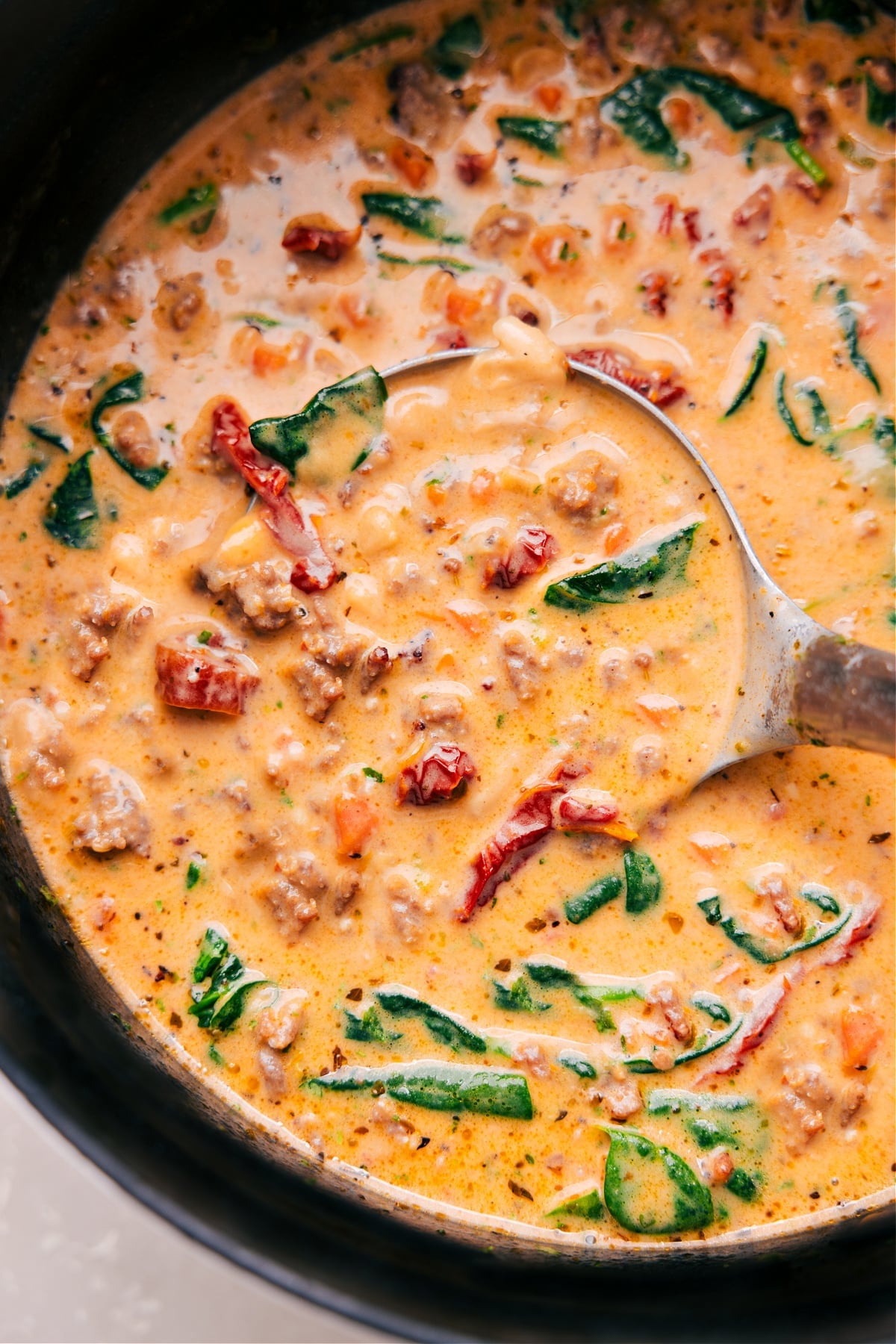 Tuscan Soup in a pot with a ladle scooping it up.