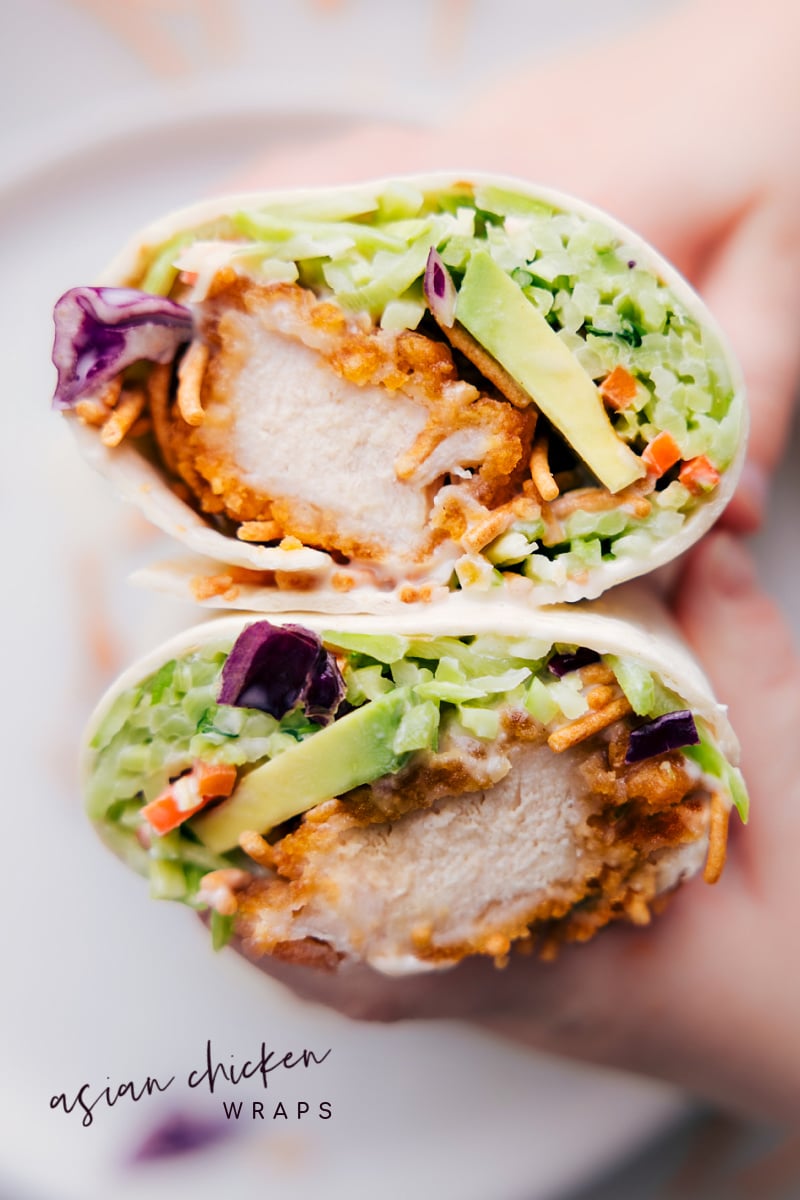 Absolute Best Asian Chicken Wraps Recipe Asian Chicken Wraps cut in half and held up to show the delicious crispy inside.