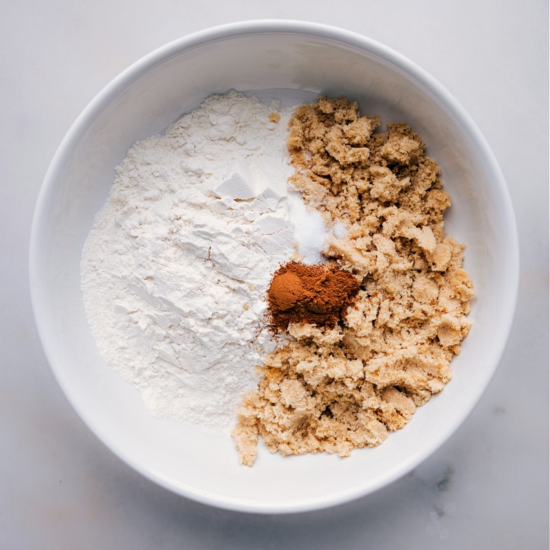 When it comes to baking, there are few things that can elevate a simple dessert to the next level quite like a crunchy, sweet, and buttery streusel topping. In this recipe, we'll spill all our secrets for "How To Make Streusel" that comes out perfectly every time! Recipe via chelseasmessyapron #guides #muffins #toppings #best #quick #easy #simple #howtomake #streusel Process shot-- image of the flour, brown sugar, and spices added to a bowl