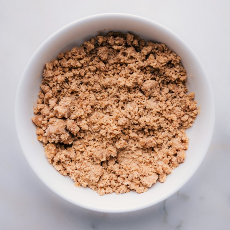 Use our recipe to make the perfect streusel for your next dessert! Recipe via chelseasmessyapron #guides #muffins #toppings #best #quick #easy #simple #howtomake #streusel Overhead image of the streusel in a bowl