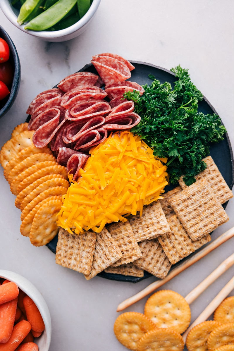 Imagine this: you're hosting a gathering, and you want to serve a fun, eye-catching appetizer that will not only impress your guests but also taste amazing. Recipe via chelseasmessyapron #sidedish #best #quick #easy #appetizer #snack #easter #spring #snackboard #carrot #cheeseball Overhead image of the appetizer ready to be enjoyed