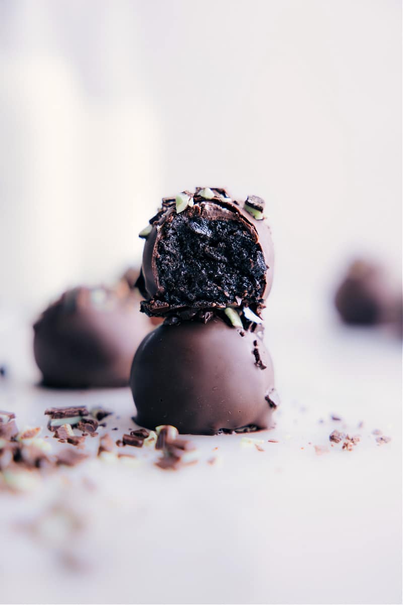 Our favorite Mint Oreo Truffles made with just three main ingredients and no baking required! With a rich, creamy, and minty Oreo filling coated in a smooth layer of chocolate, every bite is pure bliss. And if you're a fan of Andes mints, you won't want to sleep on the optional garnish of chopped mints on top! Recipe via chelseasmessyapron #dessert #best #quick #easy #simple #treat #chocolate #stpatricksday #mint #oreotruffles Image of the Mint Oreo Truffles stacked on top of each other