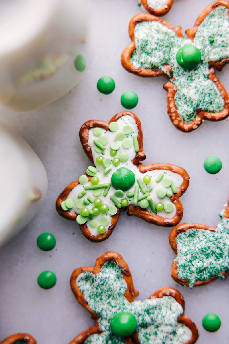 Transform a few simple ingredients into some downright delicious Pretzel Shamrocks -- perfect for St. Patrick's Day! Whether you're looking for a fun activity to do with the kids or a last-minute party snack, these Pretzel Shamrocks are the perfect thing to make! Recipe via chelseasmessyapron #dessert #best #quick #easy #simple #familyfriendly #stpatricksdays #stpatricks #pretzel #shamrocks Up-close overhead image of the St. Patrick's Day treat