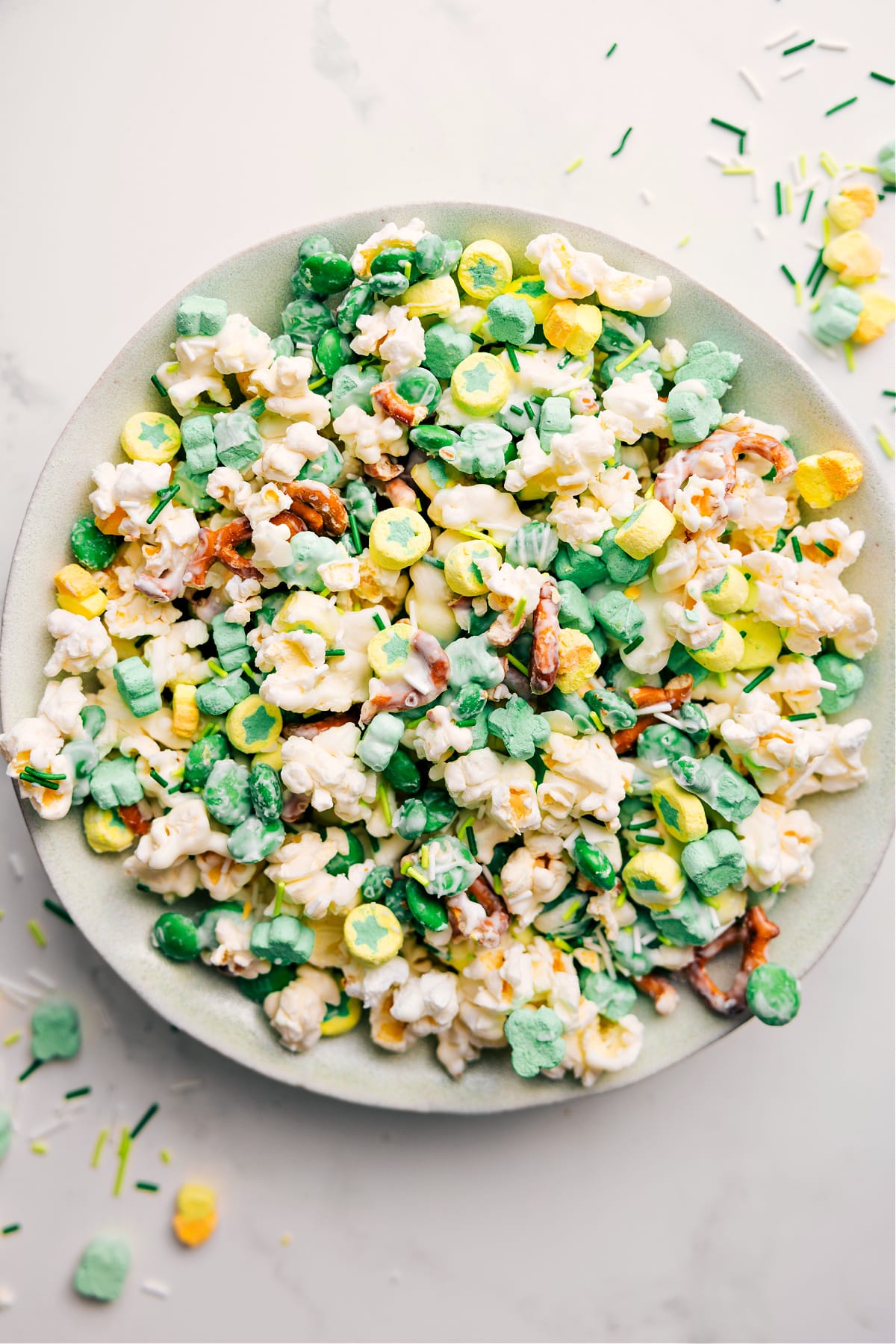 The Ultimate St. Patrick's Day Popcorn St. Patrick's Day Popcorn in a bowl with marshmallows, sprinkles, and white chocolate.