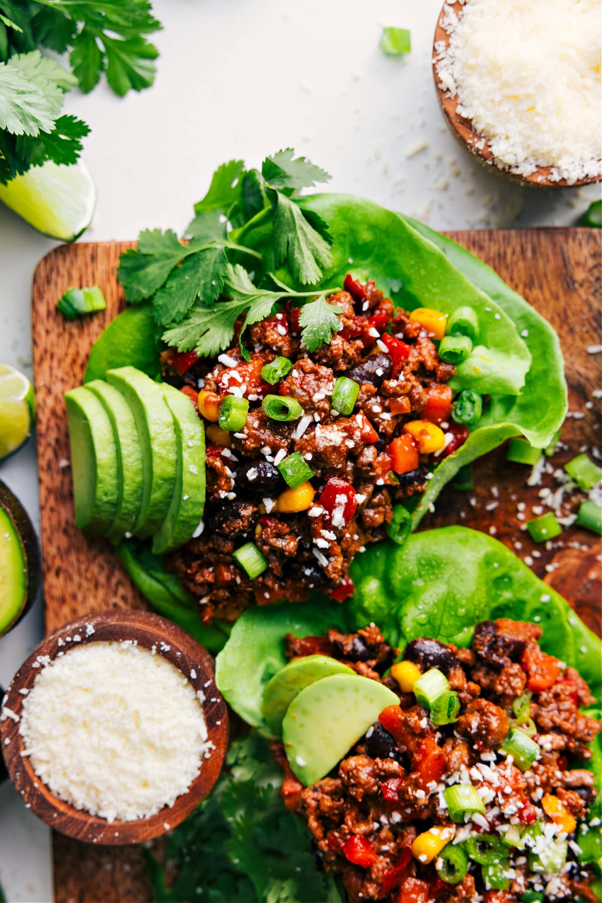 Turkey lettuce wraps topped with green onions, cotija cheese, and avocado.