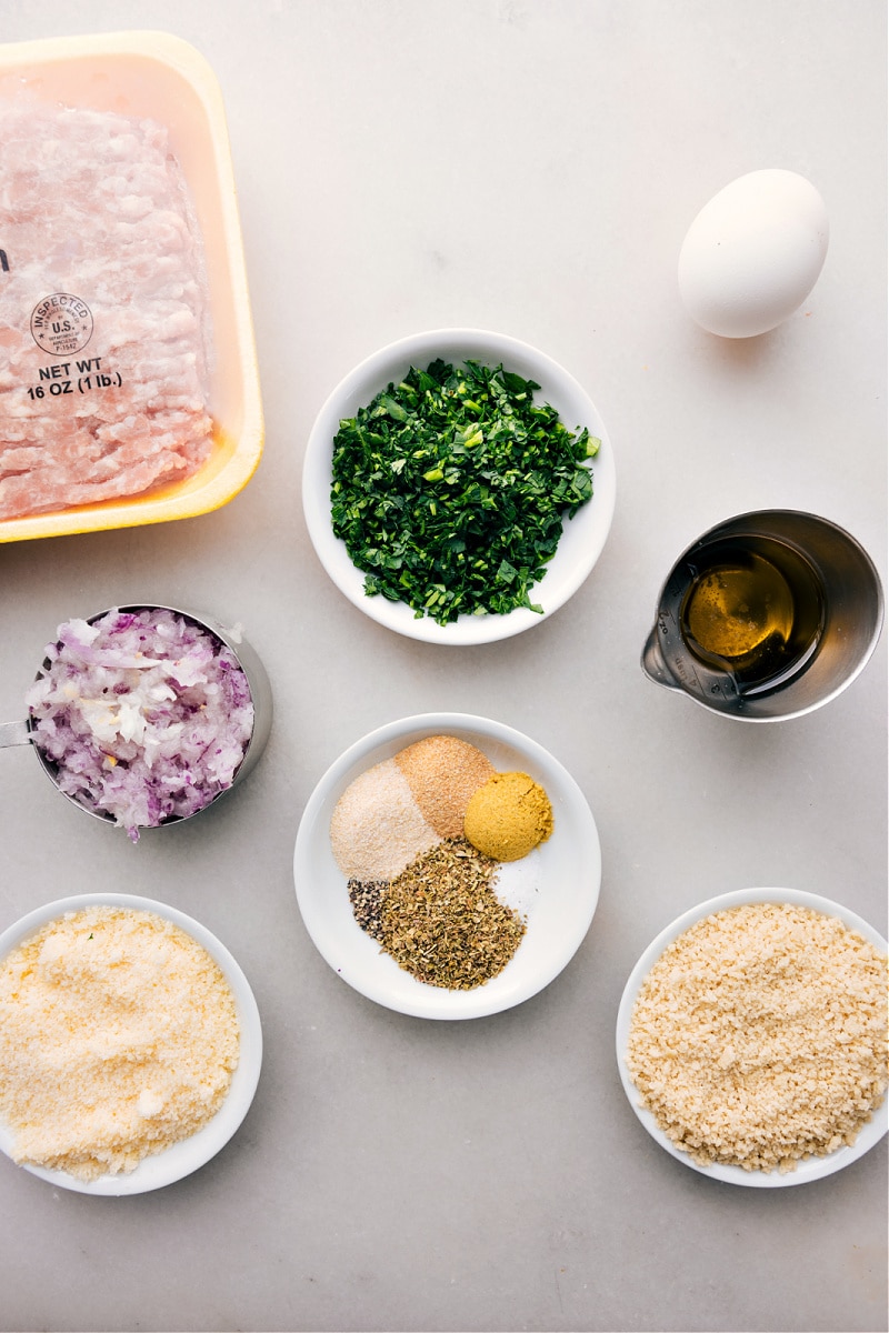 Chicken Meatballs are a tasty and nutritious alternative to traditional beef and pork meatballs. Plus, there's no need to slave over browning meatballs on the stovetop—these meatballs are baked all at once! Serve them with our favorite pesto pasta for a delicious and satisfying meal that will become a new family favorite! Recipe via chelseasmesssyapron #dinner #quick #easy #simple #familyfriendly #cleaneating #protein #chicken #meatballs Ingredient shot-- image of all the ingredients used in this dish