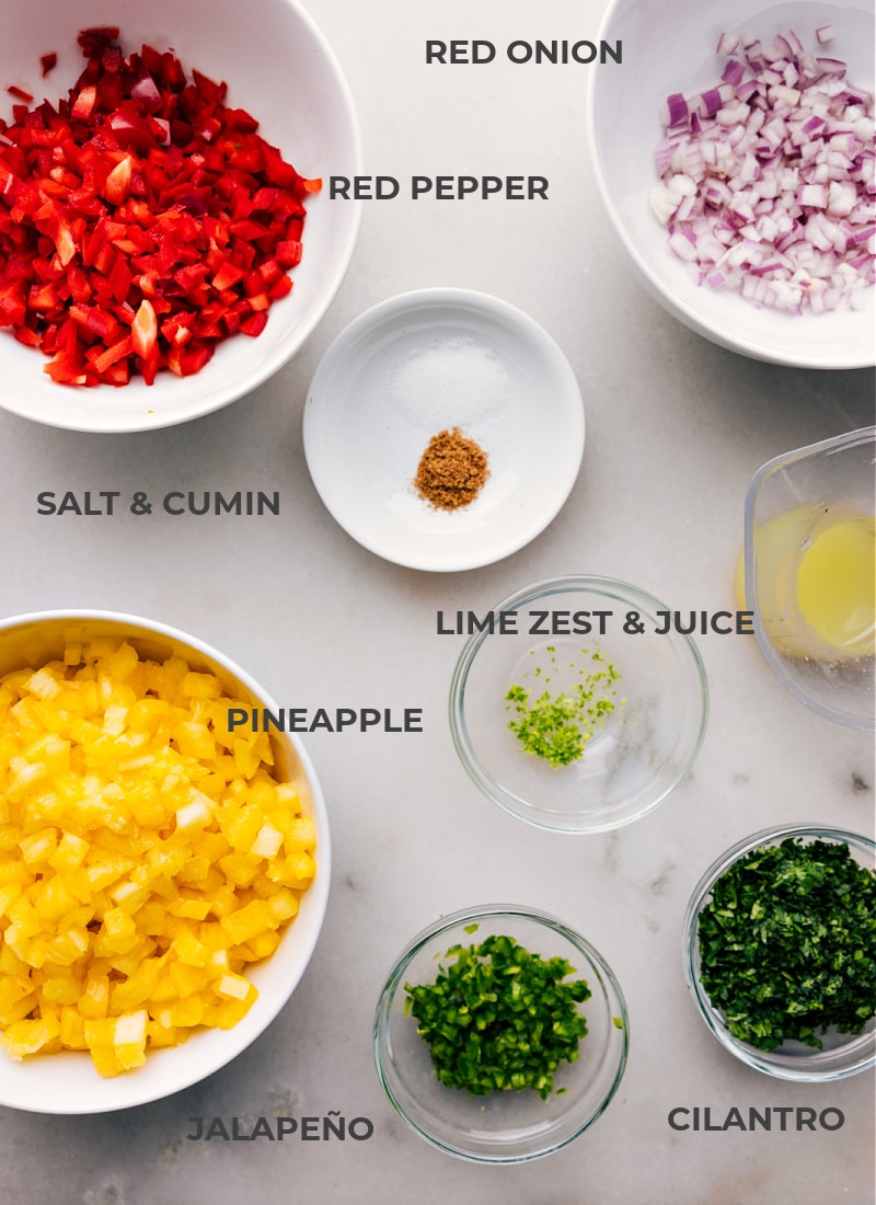 All The Ingredients You Need The ingredients for this recipe, including pineapple, red onion, red pepper, salt, cumin, lime zest, lime juice, cilantro, and jalepeno.