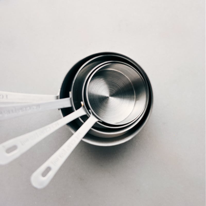 Check out our guide to measuring ingredients, complete with a free printable Kitchen Conversion Chart! Simply download the chart, laminate it, and post it on the inside of a cabinet or in your pantry for quick reference. Recipe via chelseasmessyapron #free #kitchenconversionchart #chart Image of the measuring cups