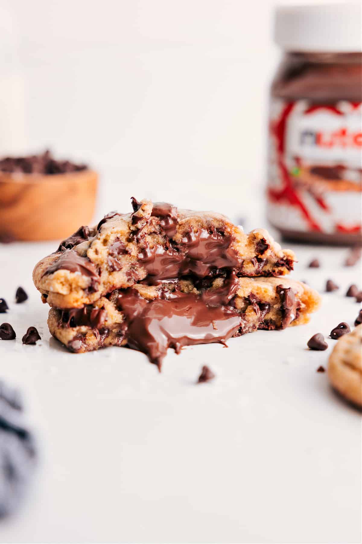Nutella Stuffed Chocolate Chip Cookies broken in half to show the Nutella filled center.