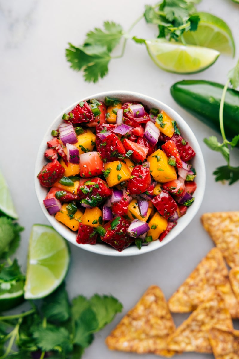 Strawberry Mango Salsa in a bowl topped with freshly chopped cilantro.