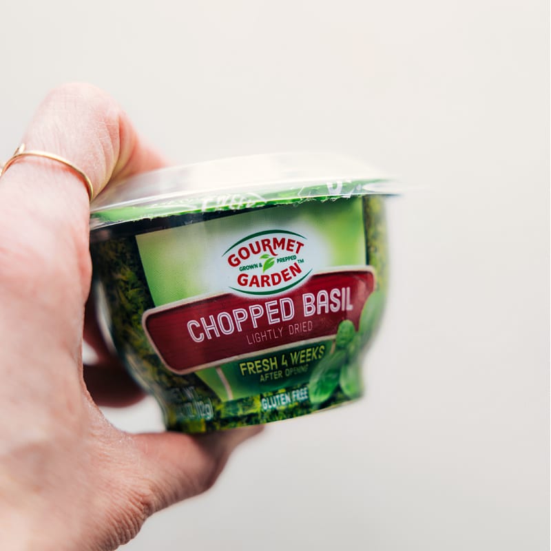 This is the best Tomato-Basil Chicken! Marinated chicken simmered with a flavorful sauce proves that simple things can be just as delicious as the fancy meals! Recipe via chelseasmessyapron #dinner #quick #easy #familyfriendly #kidfriendly #lowcarb #healthy #mealprep #tomatobasil #chicken Image of the chopped basil used in this recipe