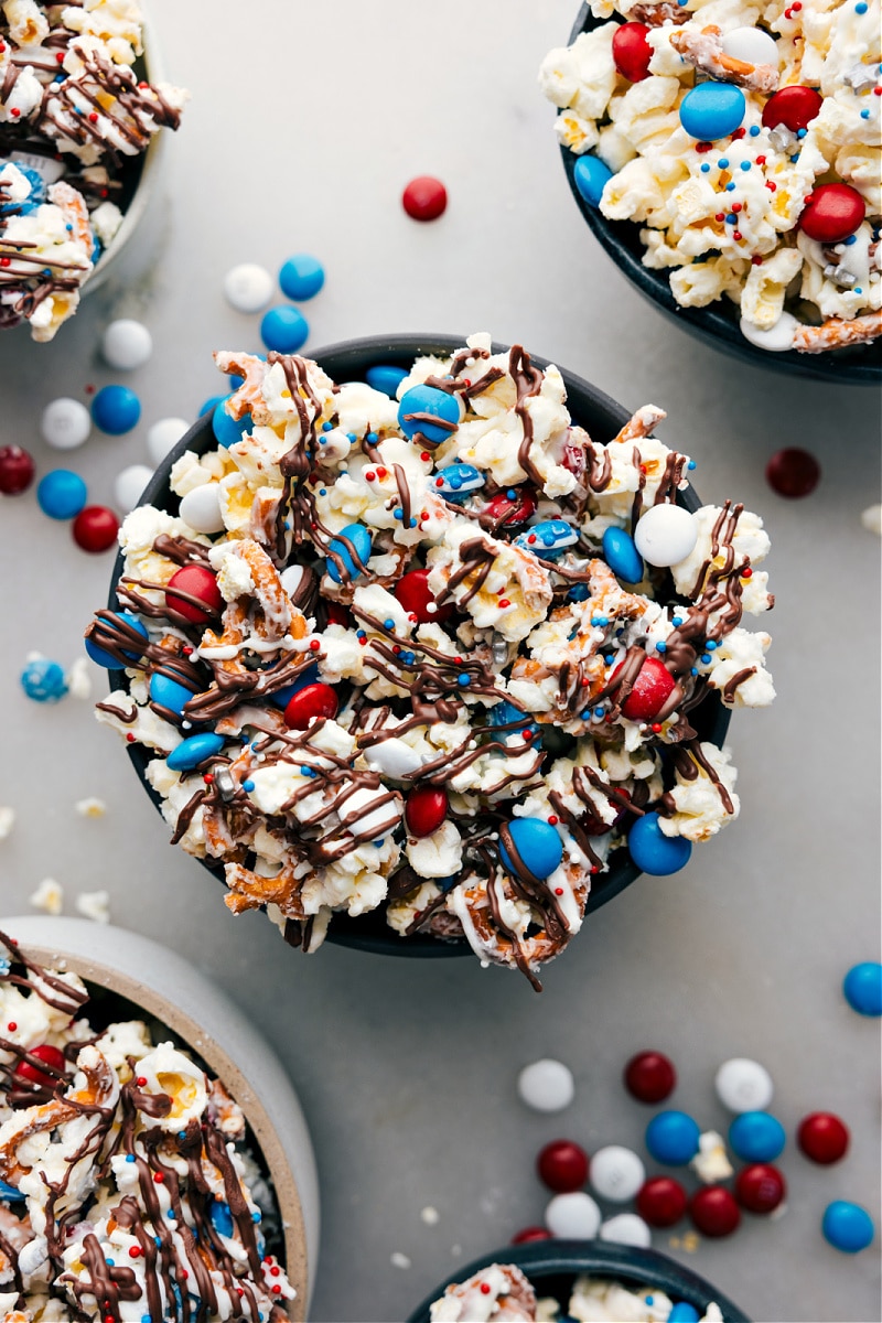 The Best 4th Of July Recipe Bowl of 4th of July Popcorn with red, white, and blue candy and pretzels.