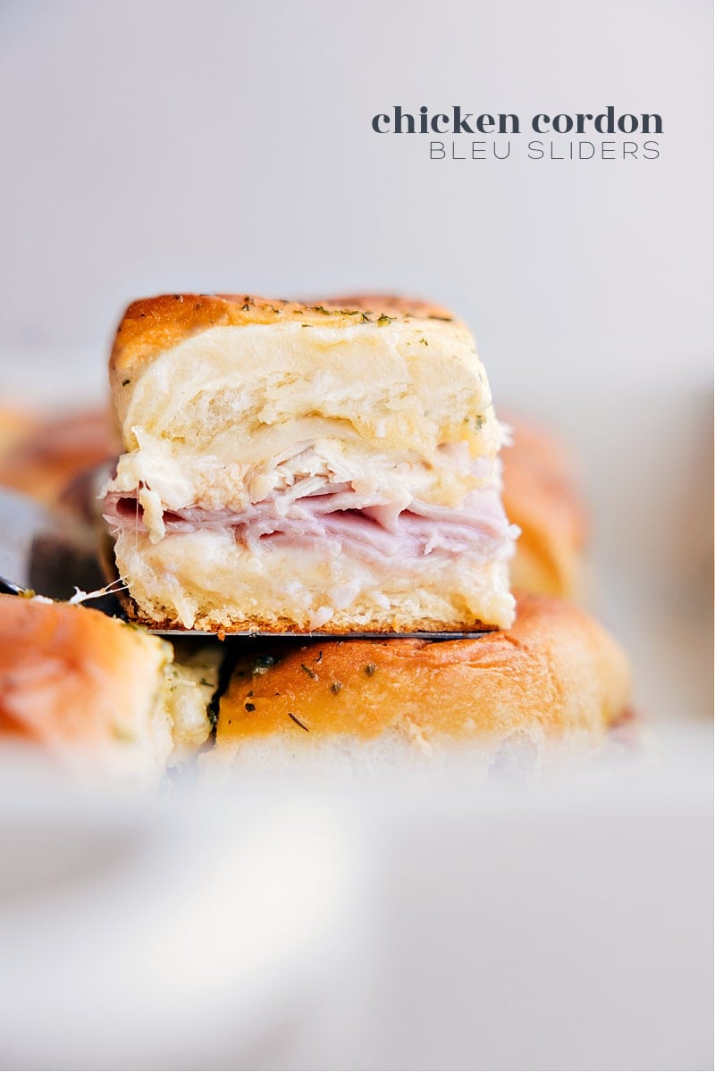 These Chicken Cordon Bleu Sliders pack a serious flavor punch! You get sweet Hawaiian rolls filled with savory ham, gooey Swiss cheese and juicy chicken, jazzed up with a tangy-sweet honey mustard sauce and garlicky butter – they're seriously delicious! Recipe via chelseasmessyapron #dinner #quick #easy #simple #familyfriendly #kidfriendly #onepan #appetizer #chickencordonbleu #sliders Image of the Chicken Cordon Bleu Sliders