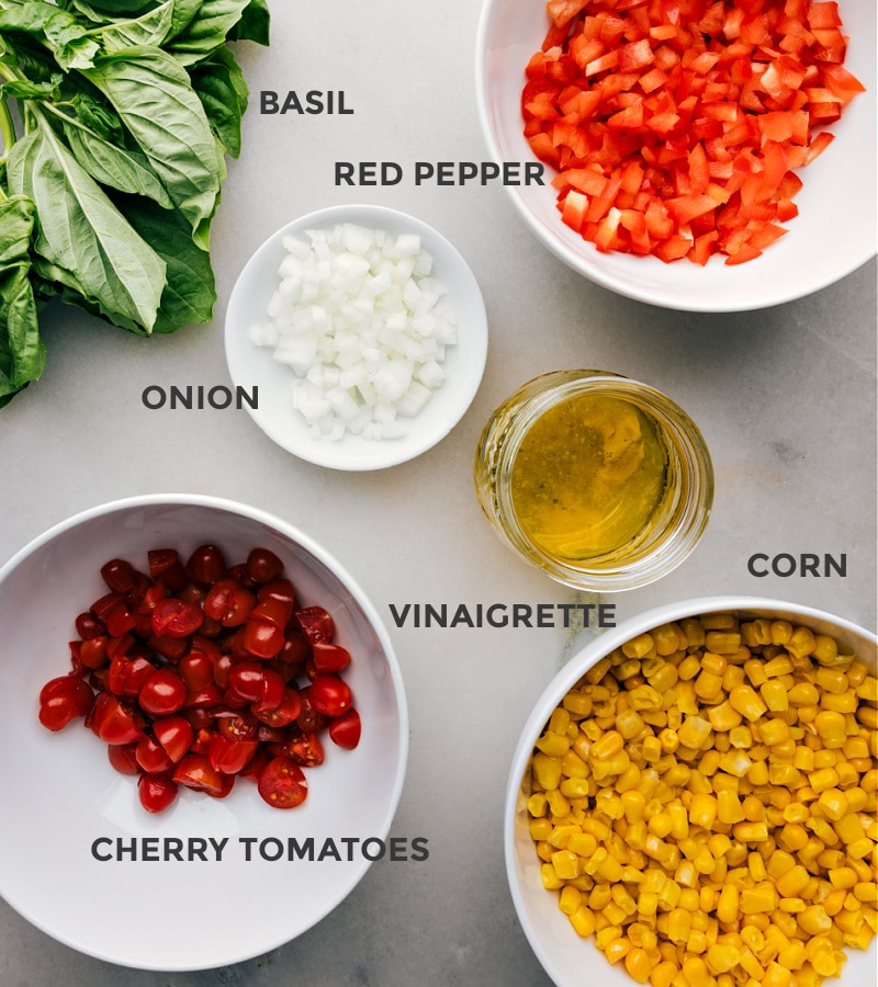 Corn and Tomato Salad recipe features a vibrant blend of sweet, juicy corn and tomatoes balanced by the crunch of diced bell pepper and onion. The tangy lime vinaigrette, spiked with a hint of maple syrup and Dijon mustard, adds a burst of citrusy freshness that ties together everything beautifully! Recipe via chelseasmessyapron #sidedish #best #quick #easy #simple #summer #summersalad #corn #tomato #salad Ingredient shot: the elements of Tomato and Corn Salad