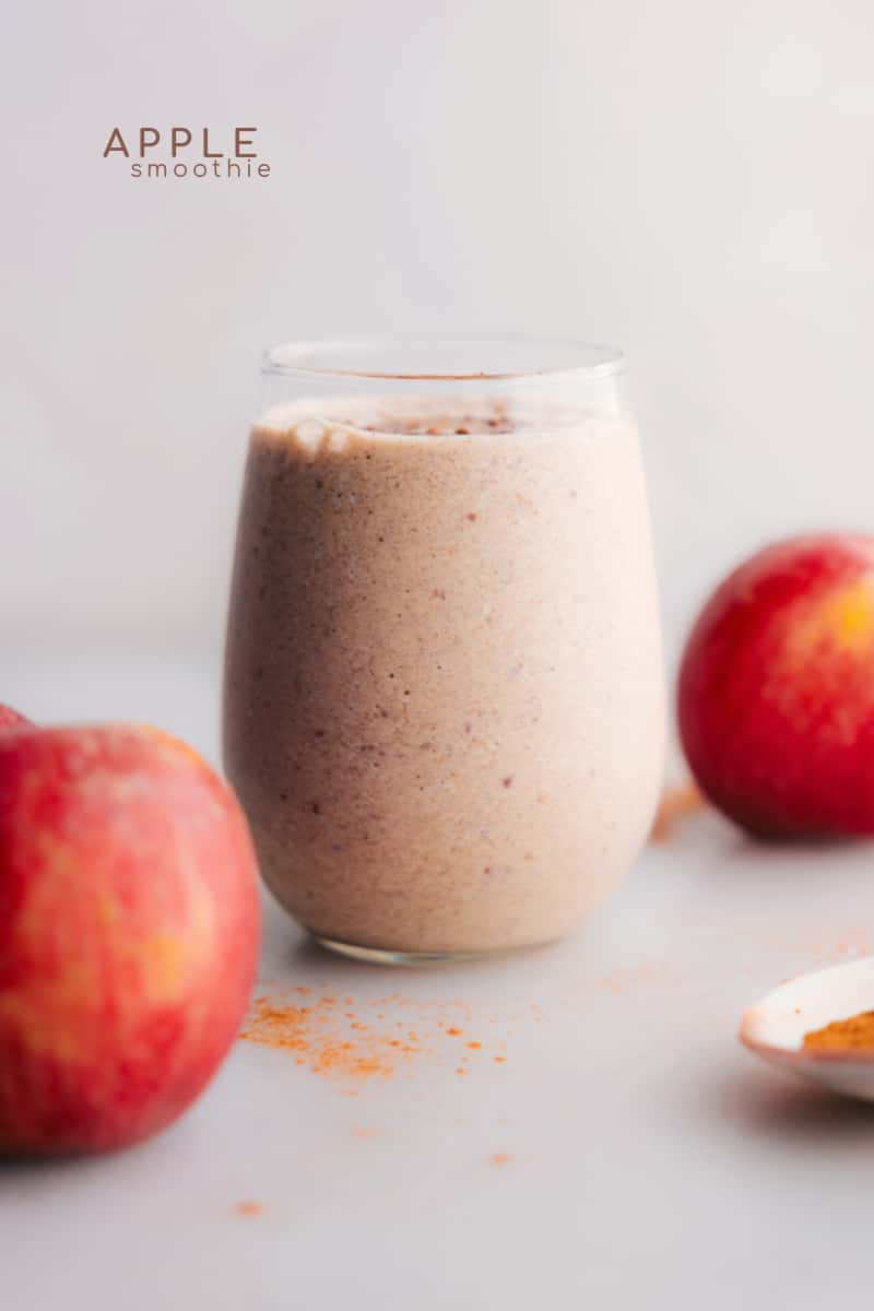 Apple Pie Smoothie in a glass, topped with a sprinkle of cinnamon.