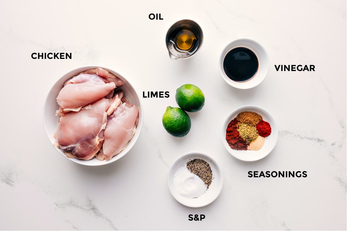 Ingredients In This Chipotle Chicken Recipe All the ingredients in this recipe prepped out for easy assembly including the chicken, limes, oil, vinegar, and seasonings.