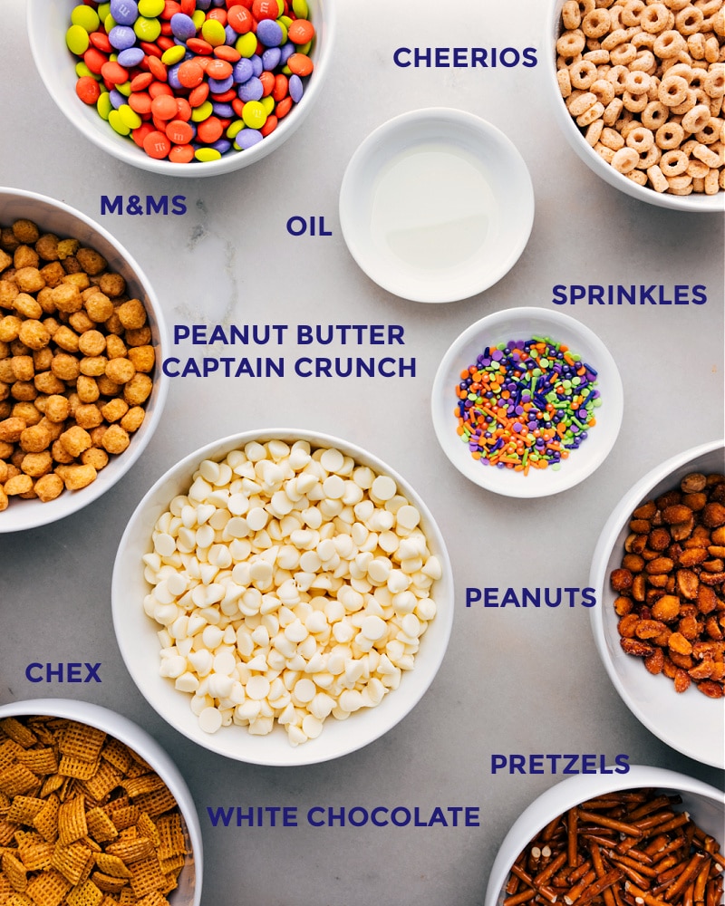 Ingredients In This Monster Munch Halloween Snack Mix All the ingredients int his recipe prepped out for easy assembly including the cereals, oil, sprinkles, peanuts, and M&Ms.