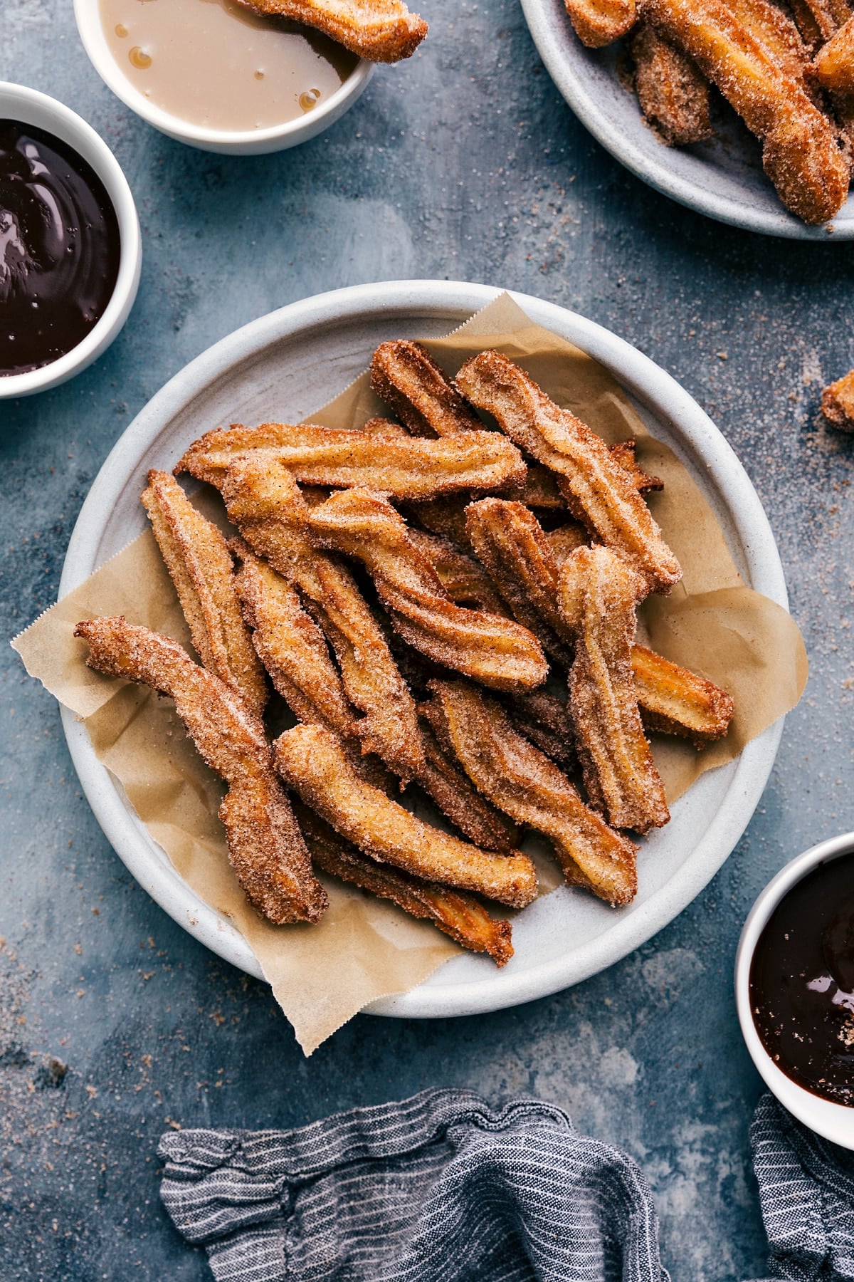 Delicious Churros with Chocolate Dipping Sauce Plate of churros served with a side bowl of rich chocolate sauce.