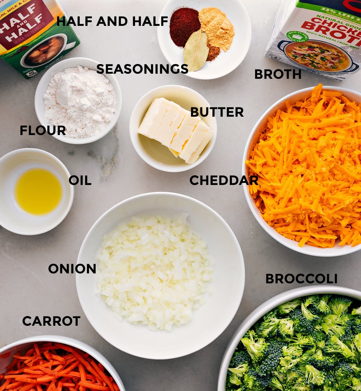 Ingredients In Broccoli Cheddar Soup All ingredients prepped for easy assembly: seasonings, broth, butter, cheese, veggies, flour, oil, and half-and-half.
