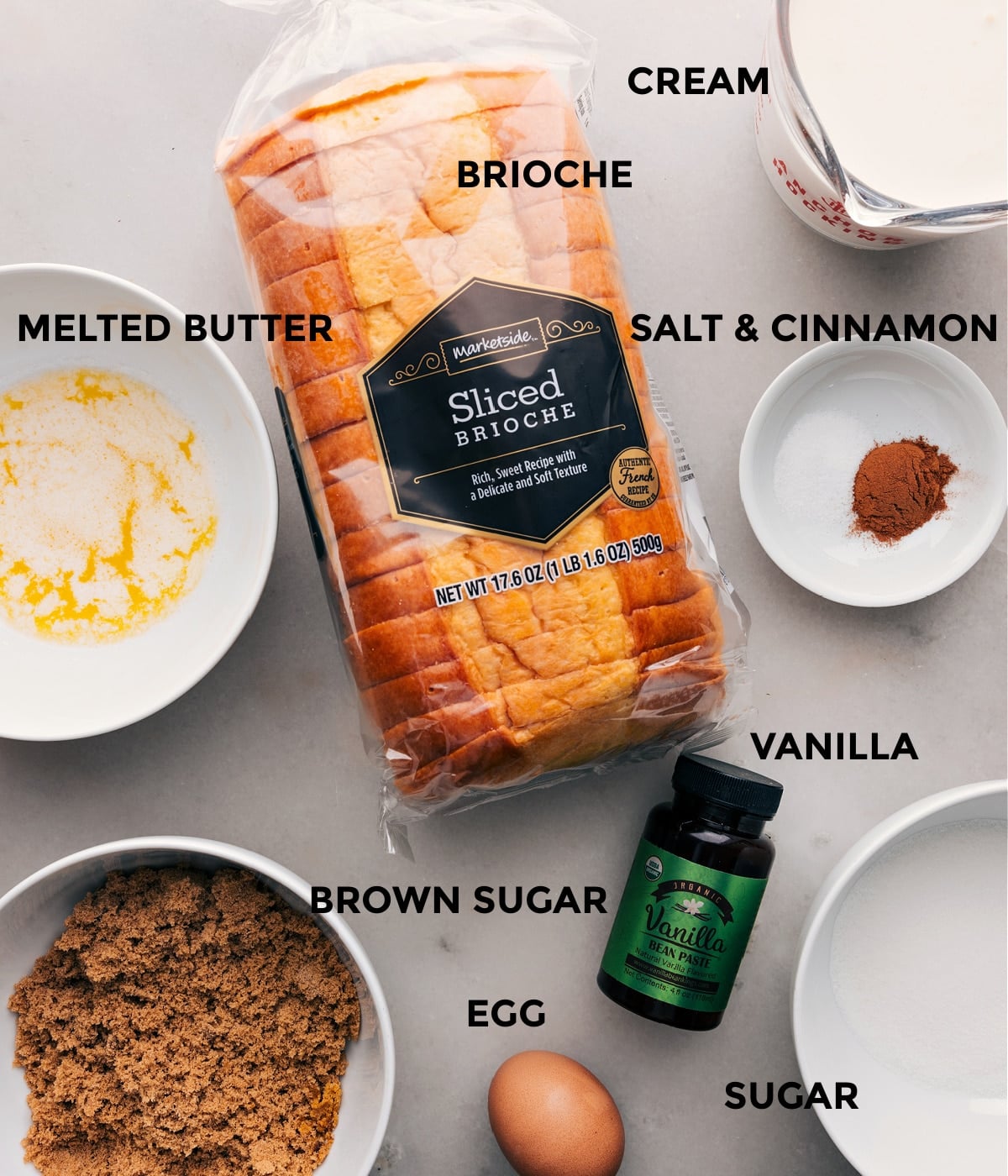 Ingredients for Bread Pudding Recipe: Brioche, Butter, Sugar, Vanilla, Eggs and More Ingredients for bread pudding recipe displayed, including brioche, melted butter, brown sugar, vanilla, eggs, and more.