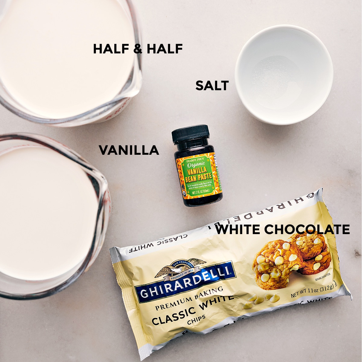 Ingredients for Delicious White Hot Chocolate - Vanilla, Half and Half, Salt, and More All the ingredients for making the delicious drink, including vanilla, half and half, salt, and more, laid out and ready for use.