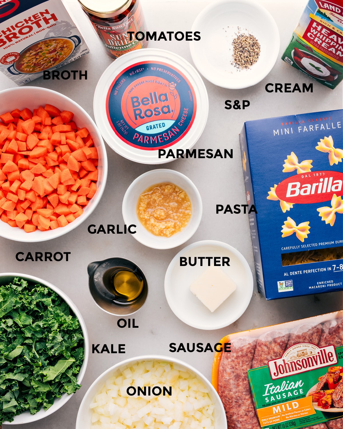 Prep all the ingredients for this recipe, including cream, seasonings, tomatoes, broth, veggies, parmesan, garlic, butter, oil, meat, and noodles, for easy assembly.