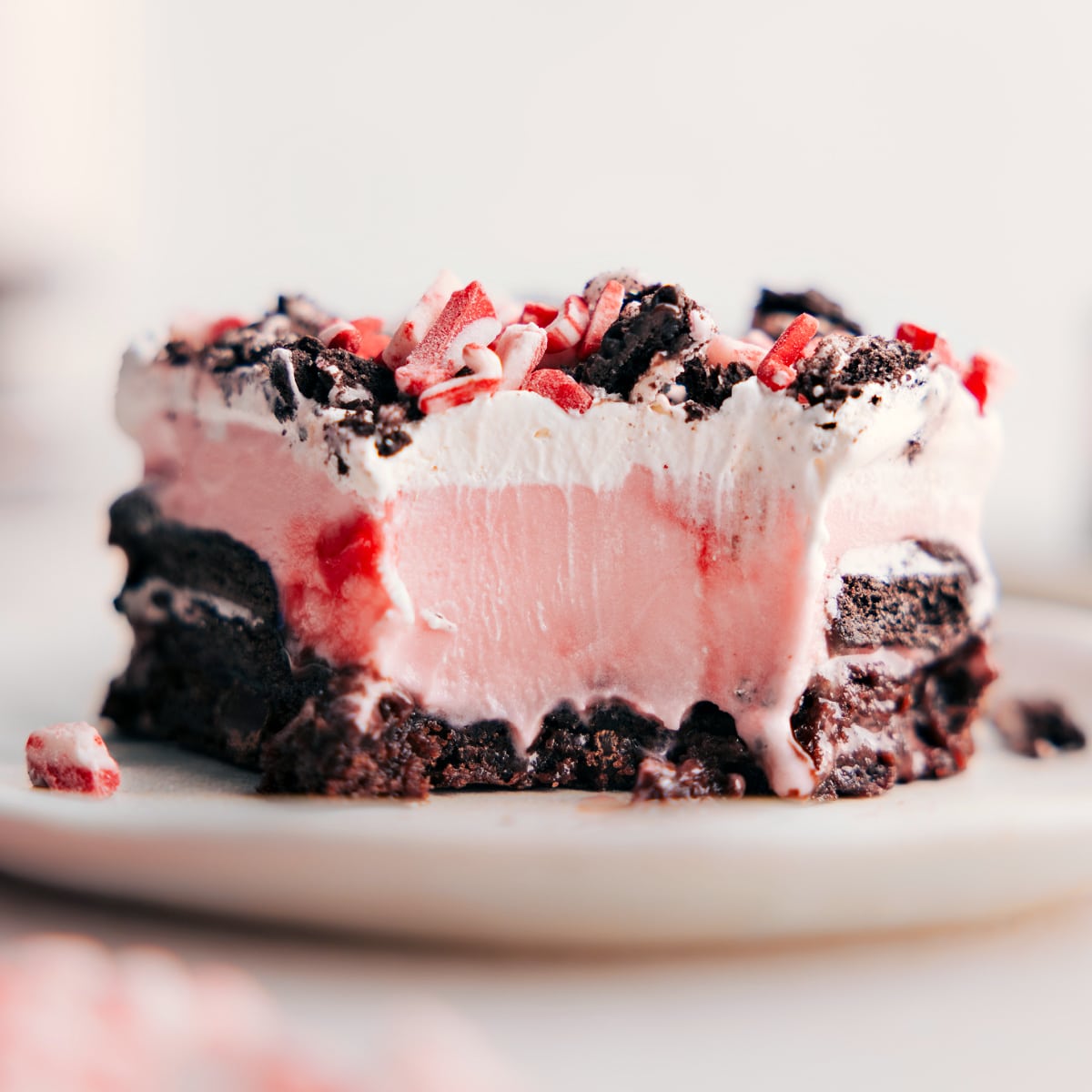 Peppermint Brownie Ice Cream Bar with a Bite Taken The finished dessert with a bite taken out, revealing its beautiful layers, highlighting the dessert's complementary flavors.