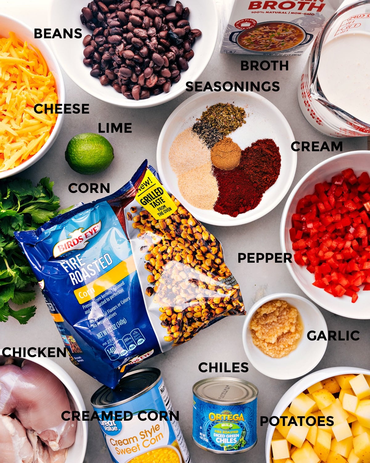 Ingredients for Southwestern Corn Chowder Recipe All the ingredients for the recipe including peppers, potatoes, chicken, spices, and other fresh produce, arranged neatly for preparation.