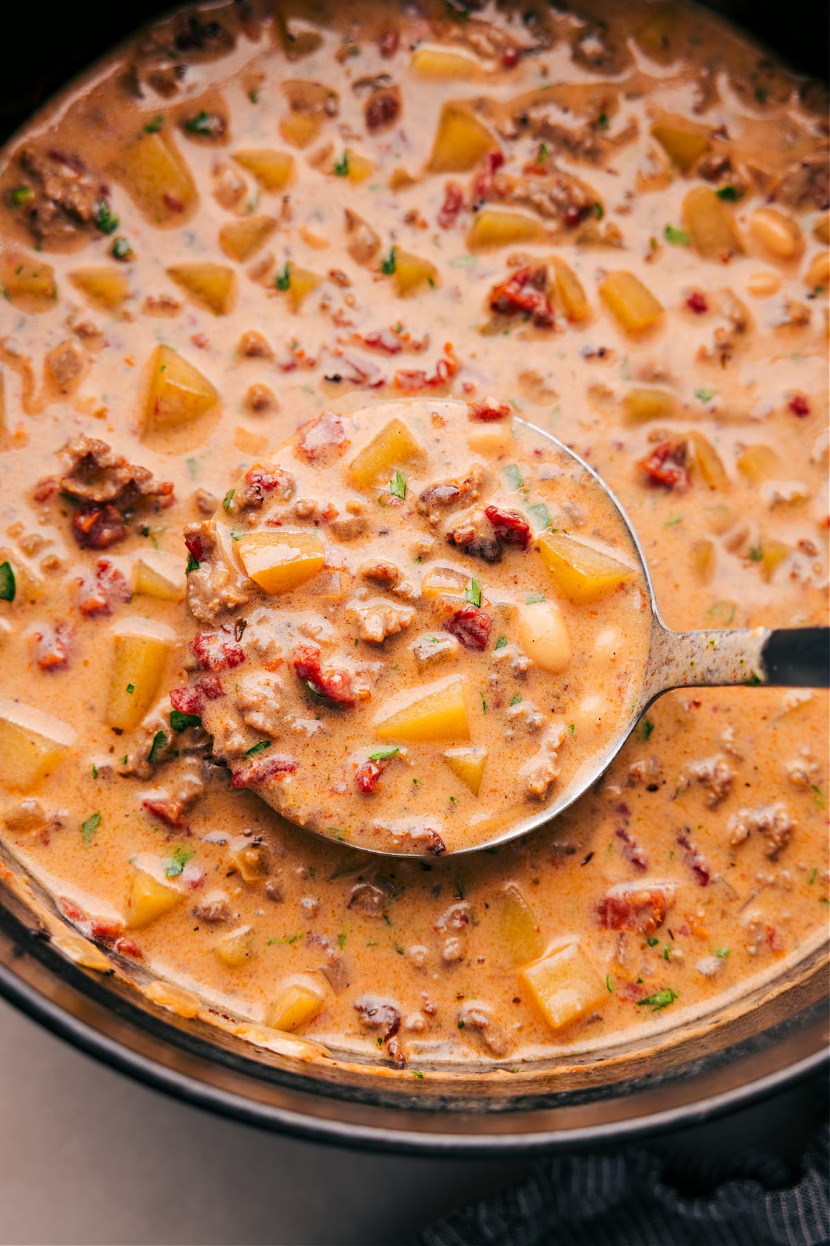 Pan of Finished Tuscan Sausage & Potato Soup A pan filled with the finished Tuscan Sausage and Potato soup, full of flavor and ingredients, warm and ready to be enjoyed as a delicious meal.