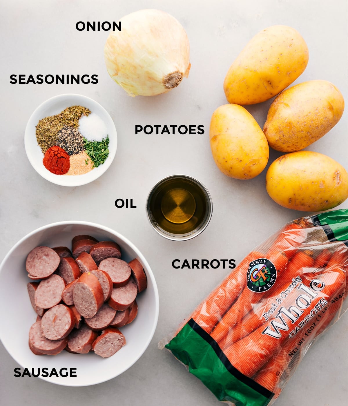 Ingredients In Hobo Foil Packets All the ingredients in this recipe including sausage, seasonings, onion, potatoes, and carrots being prepped for easy assembly.